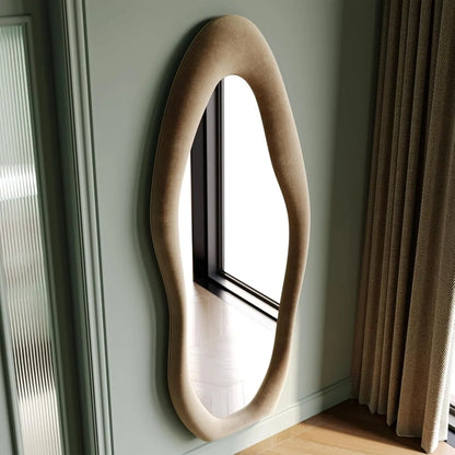 Full-length irregular wave mirror hanging or leaning against the wall. 63 x 24"