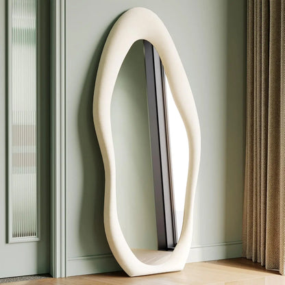 Full-length irregular wave mirror hanging or leaning against the wall. 63 x 24"