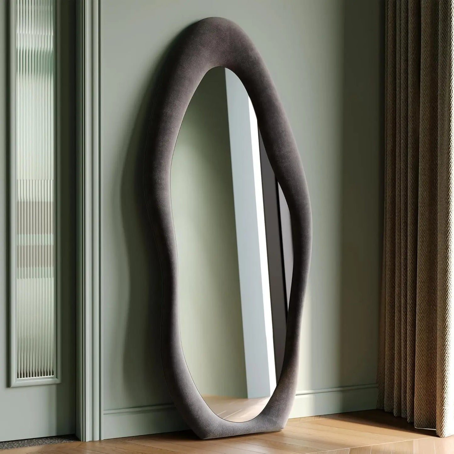 Full-length irregular wave mirror hanging or leaning against the wall. 63 x 24"