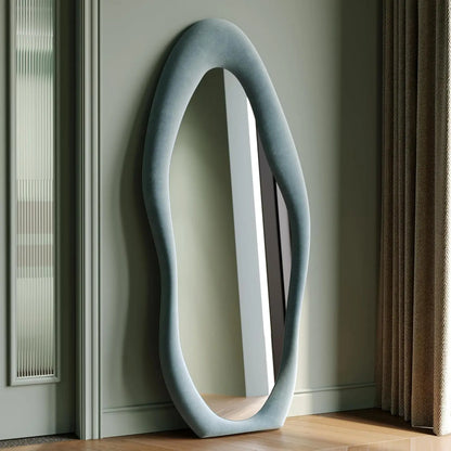 Full-length irregular wave mirror hanging or leaning against the wall. 63 x 24"